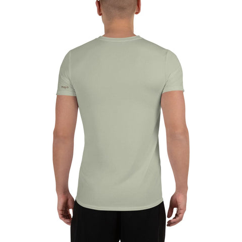 A person is seen from behind against a white background, wearing a light green "Soldier On" Men's Athletic T-shirt from the Magick brand, featuring a moisture management system. They have short hair and are also wearing black shorts made from four-way stretch sports mesh fabric for maximum comfort.