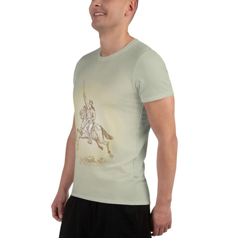 A person wearing the "Soldier On" Men's Athletic T-shirt by Magick, featuring a vintage illustration of a knight on horseback raising a lance in light green. The four-way stretch sports mesh fabric offers comfort as they smile in a relaxed pose, paired with dark shorts.