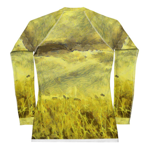 The "My Kind of Day" Women's Rash Guard by Magick is a yellow long-sleeve piece with an abstract design reminiscent of a grassy field, showcasing olive, brown, and yellow tones. Made from four-way stretch fabric, it provides a textured and nature-inspired look along with UPF 50+ protection.