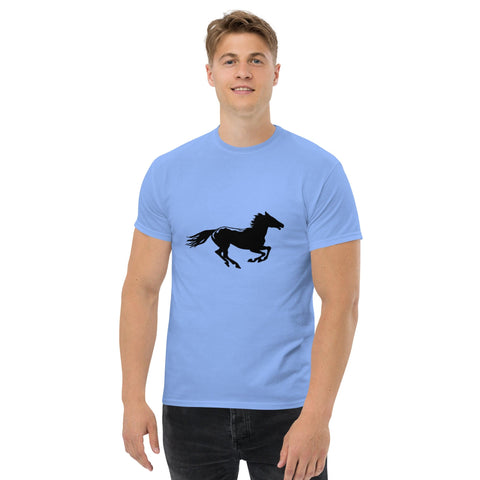 A man wears the Magick "Onward" Men's Classic Tee, in light blue with a black running horse silhouette. Set against a white background, he pairs it with black pants and a slight smile, capturing effortless streetwear style.