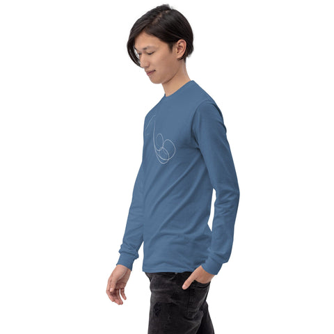 A person with long dark hair is standing and looking down, wearing a blue "Animal Force" Men’s Long Sleeve Shirt by magickwear, featuring a minimalist design on the front, paired with black jeans. The 100% cotton shirt contrasts against the plain white background.