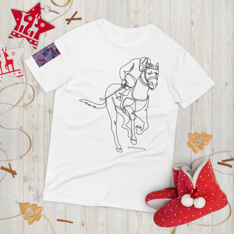 The magickwear "Keep Going" Short-Sleeve T-Shirt, crafted from 100% ring-spun cotton, showcases a minimalist line drawing of a jockey on horseback. Elegantly displayed on a wooden surface, adorned with Christmas decorations such as red ornaments and patterned slippers, it perfectly captures the essence of comfort and style for the festive season.