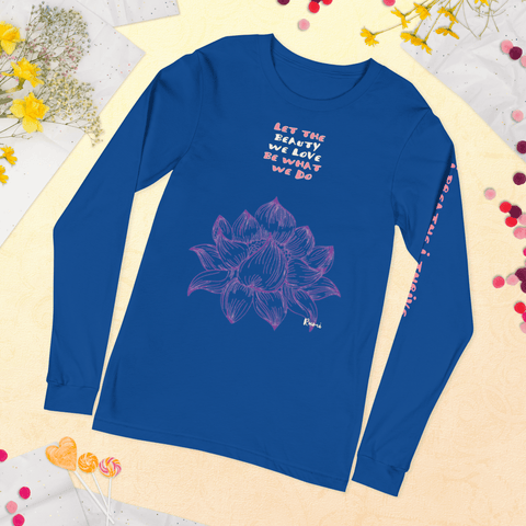 The "Beauty We Love" Unisex Long Sleeve Lettering Tee by magickwear is a blue, comfortable, and stylish shirt featuring a pink lotus flower design in the center. Above the lotus, white text reads "LET THE BEAUTY WE LOVE BE WHAT WE DO." The right sleeve is adorned with the phrase "beauty inspires" in pink. This versatile design shirt is displayed on a yellow textured surface with flowers and lollipops.