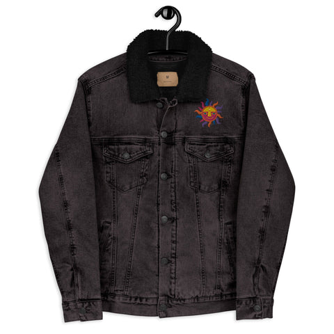 Snug Warm!" by magickwear is a unisex denim sherpa jacket in black, featuring a fuzzy collar and a vibrant sun graphic on the left. It hangs on a black hanger against a stark background, blending style with eco-conscious fashion.