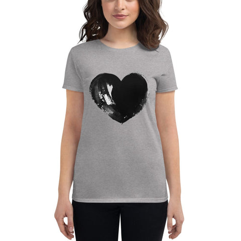 A person with long dark hair stands against a plain background, wearing the chic "Full Heart" Tee by magickwear—a gray t-shirt highlighted with a bold, black brush-stroke-style heart design in the center.