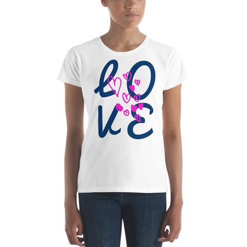 Wearing magickwear's "LOVE Big" Women's Short Sleeves Lettering T-shirt, crafted from 100% cotton, and featuring "LOVE" in navy blue with pink hearts, a person confidently stands in blue jeans against a plain background.